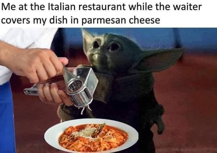 This meme features a picture of the character Baby Yoda from the Star Wars series, holding a plate of spaghetti and a cheese grater. The text above the image reads "Me at the Italian restaurant" and below it says "when they put parmesan cheese on my spaghetti". The meme is a humorous take on the common experience of being surprised or annoyed when a restaurant adds a topping or ingredient that you didn't ask for.
